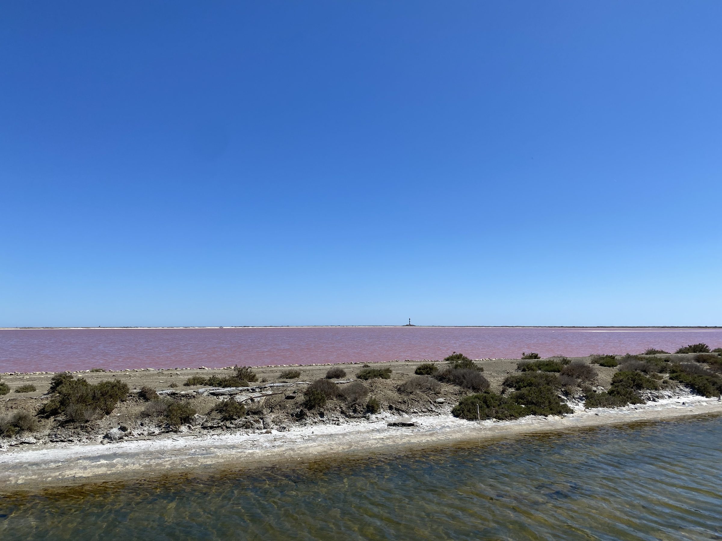 The pink salt pans of Salin-de-Giraud under a wide blue sky